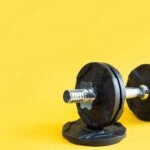 dumbbell-with-disks-on-a-yellow-background-close-up-sports-lifestyle-.jpg